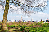 View of the skyline of Antwerp across the River Schelde from a park, Scheldekaaien Linkeroeve, Antwerp, Belgium, Europe