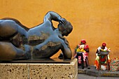 Colombia, Bolivar Department, Cartagena, listed as World heritage by UNESCO, Santo Domingo square, fruit sellers in front of a Botero sculpture