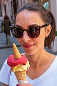 Italy, Campania, Naples, historical centre listed as World Heritage by UNESCO, young italian woman with ice cream