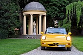 Italy, Tuscany, Florence, listed as World Heritage by UNESCO, Alfa Romeo Duetto Spider yellow cabriolet in the gardens of the Palazzo Della Gherardesca, 5 star palace Four Seasons Hotel Firenze