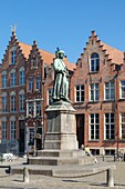 Belgium, Western Flanders, Bruges, historical centre listed as World Heritage by UNESCO, Jan Van Eyck square, statue of the Flemish painter and brick facades with stepped gables