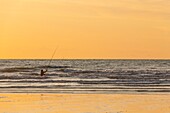 France, Somme, Ault, anglers on the beach of Ault as twilight settles down gradually