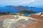 Italy, Sicily, Aeolian Islands, listed as World Heritage by UNESCO, Vulcano Island, the crater of volcano della Fossa and its sulfur fumaroles, the island of Lipari then Salina island in the background (aerial view)