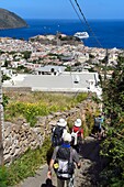 Italy, Sicily, Aeolian Islands, listed as World Heritage by UNESCO, Lipari Island, hikers descending to the town of Lipari