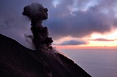 Italy, Sicily, Aeolian Islands, listed as World Heritage by UNESCO, Stromboli island, eruption and projection of lava bombs on the slopes of the active volcano at sunset