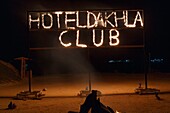 Marocco, Oued Ed-Dahab, Dakhla,Dakhla Club Resort, flaming letters on a portico on the beach in the middle of the night