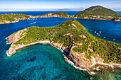 Guadeloupe, Les Saintes, Terre de Haut, the bay of the town of Terre de Haut, listed by UNESCO among the 10 most beautiful bays in the world, Dominica island in background (aerial view)