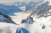 Switzerland, Canton of Bern, Bernese Oberland (highlands), Grindelwald, view to Jungfraufirn and Aletsch Glacier, part of Jungfrau Aletsch Bietschhorn UNESCO World Heritage Site and also called the Top of Europe (highest railway station in Europe), View to Sphinx Observatory (3571m) at mountain Sphinx near Jungfraujoch (3454m) (aerial view)