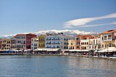 Greece, Crete, Chania, venetian port, pedestrian promenade with Lefká Óri or white mountains in the background