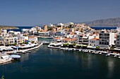 Greece, Crete, Agios Nikolaos, Lake Voulismeni, basin connected to the sea lined with cafes and taverns