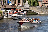 Belgium, West Flanders, Bruges, historical center listed as a UNESCO World Heritage, boats with tourists in front of the bridge Saint Jean Népomucène, Wollestraat