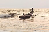 Cameroon, South Region, Ocean Department, Kribi, fishermen in canoes paddling in the waves