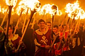 United Kingdom, Scotland, Shetland Islands, Mainland, Lerwick, Up Helly Aa festival, squad of Guizers parading to the site where the viking longship will be set on fire