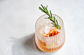 Top view of elegantly presented vodka tonic with a twist of grapefruit and a sprig of rosemary, symbolizing sophisticated refreshment