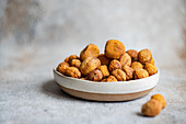 A bowl filled with Arashan Kandak, a type of sun-dried apricot from Central Asia, known as a healthy snack option