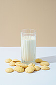 A warm and inviting image showcasing homemade raisin biscuits accompanied by a refreshing glass of cold milk, set against a neutral background.