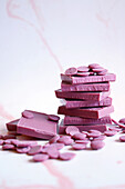 Ruby chocolate made from selected botanical cocoa bean varieties. Bars and callet melting buttons.