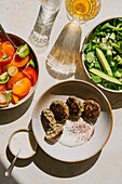 Mezze table in harsh light on a stone background