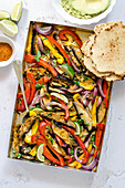 Fajitas with portobello mushrooms and peppers, avocado and tortillas