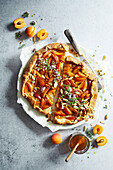 Abricos galette, cut in half, on a grey background