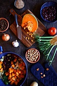 Preparation of a Sardinian-style long-simmered minestrone soup. Flatlay from top to bottom.