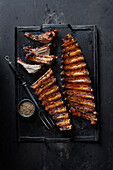 Grilled pork BBQ spareribs on a dark backround