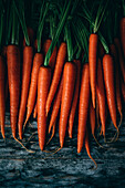 Stacked Carrots against a wooden background