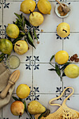 Fresh lemons and pears with leaves. Bag of yellow lemons and pears with fresh lemon tree leaves on vintage blue tile background. Flatlay