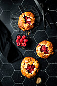 raspberry galletes on black backdrop