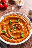 Dish of fresh tomato sauce with basil, cherry tomatoes and garlic