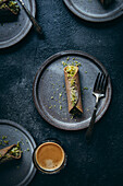 Cannoli with pistachios against blue background