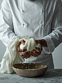 Action shot of a chef making Labneh