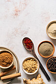 Ground spices in bowls on a neutral background background