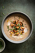 Mushroom soup with wild mushrooms on a green background.