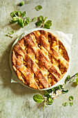 Homemade apple pie on a light green stone background