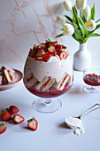 Pink lamington cake and strawberry yoghurt jelly layer trifle dessert.