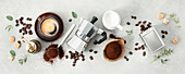 Flat lay with Moka pot, espresso cup, ground coffee, milk, sugar and coffee beans on a grey concrete background. Header with brewing coffee ingredients.