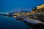 View of boats and restaurants in the Waterfront at dusk, Cape Town, Western Cape, South Africa, Africa