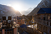 Wide angle view over the rooftops of Kyanjin Gompa with gold light of sunset, Lang Tang Valley Trek, Himalayas, Nepal, Asia