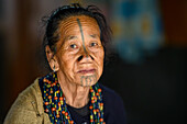 Portrait of a woman with nose plugs and facial tattoo, Apatani Tribe, Ziro Valley, Arunachal Pradesh, India, Asia