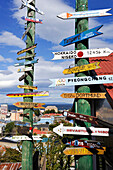 Sign post showing distance of some cities across the world from Punta Arenas, Strait of Magellan, Peninsula of Brunswick, Chile, South America