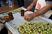 Men preparing olives for consumption, Mardin bazaar, Turkey, Asia Minor, Asia