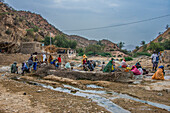 Men and women sitting in a hot spring in the lowlands of Eritrea, Africa