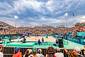 Jumping and cheering for Team USA and the Paris 2024 Olympics in Paris in front of the Eiffel Tower beach volleyball stadium, Paris, France, Europe