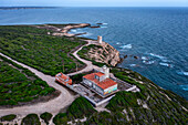 Lighthouse on Mannu Cape wild coast of Sardinia, aerial drone view at sunset, Sardinia, Italy, Mediterranean, Europe