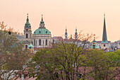 Tower and dome of St. Nicholas Church and St. Thomas Church in Lesser Town at sunset, Prague, Czech Republic (Czechia), Europe