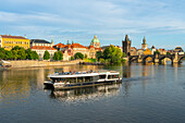 Tourist boat on Vltava River with Charles Bridge in background, UNESCO World Heritage Site, Prague, Bohemia, Czech Republic (Czechia), Europe