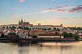 Prague Castle rising above Vltava River at sunset, UNESCO World Heritage Site, Prague, Bohemia, Czech Republic (Czechia), Europe