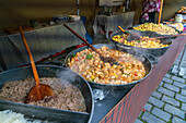 Different types of meals in big saucepans on display at farmers market on Vltava riverside near Palackeho namesti, Prague, Czech Republic (Czechia), Europe