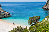 Woman walking on the Beach of Dafines Bay, Peninsula of Karaburun, within the Karaburun-Sazan Marine Parc, Vlore Bay, Albania, Europe